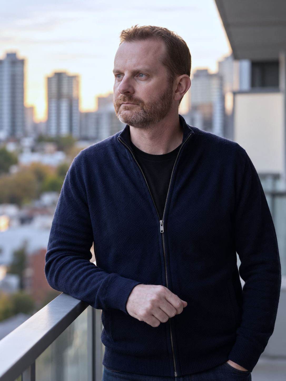 Russell Morris on a city balcony at dusk